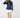 Navy women’s long sleeve quarter-zip golf pullover paired with a white golf skort and navy socks.