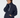A woman wearing a navy blue quilted lightweight jacket with a white zipper and patterned leggings, posing against a light gray studio background.