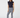 Women’s navy golf leggings with white patterned print paired with a navy sleeveless ruffle golf polo.