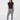 Women’s navy golf leggings with white patterned print paired with a navy sleeveless ruffle golf polo.