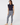 Women’s navy golf leggings with white patterned print paired with a navy sleeveless ruffle golf polo.