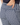 Close-up of a person wearing navy and white geometric patterned golf pants, with a hand in the back pocket.