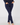 A person wearing dark navy blue golf leggings with side slit details, standing barefoot.