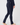 A person wearing dark navy fitted golf pants with a vertical dark velvet stripe down the side and a small star detail near the right back pocket, shown from the back.