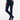 A model wearing navy blue slip-on boots, a pair of dark navy blue slim-fit trousers, and styled with a white long-sleeve top.