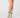 A person's legs wearing green and white patterned ladies golf socks with a matching green and white skirt.
