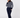 A woman wearing the Donna navy blue and white patterned turtleneck golf sweater with matching navy pants and socks.