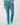 A person wearing slim-fit teal pants with a matching long-sleeve top and teal socks.