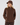 A woman wearing brown quilted golf hat with a brown zip-up jacket with matching brown pants.