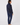 A woman shown from the back wearing a navy blue fleece zip-up jacket and matching navy blue pants.