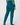 Teal women’s golf jogger pants with high-rise waistband and cuffed ankles, modeled from the back.