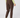 A person shown from the back wearing brown jogger-style golf pants, a light yellow-green long-sleeve top, and colorful patterned socks.