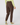 A person shown from the back wearing brown jogger-style golf pants, a light yellow-green long-sleeve top, and colorful patterned socks.