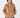 A woman wearing a tan quilted quarter-zip pullover jacket with a stand-up collar and front pockets, paired with black pants, front view.