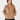 A woman wearing a tan quilted quarter-zip pullover jacket with a stand-up collar and front pockets, paired with black pants, front view.