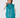 A woman modeling a shiny teal quilted puffer golf vest over a white long-sleeve top and matching teal pants, with a teal patterned headband.