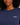 A close-up of a woman wearing a navy blue long-sleeve golf crewneck sweatshirt with a white embroidered 'GOLF' logo with a star on the left chest.