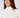 A smiling woman wearing the Natasha ribbed cream turtleneck top.
