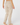 Parchment women’s heavyweight golf trousers with welt back pockets, shown from the back.