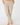 A person wearing light beige heathered lounge pants with an elastic waistband and side pockets, paired with a tan long-sleeve top.