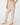 A person wearing beige heathered lounge pants with a relaxed straight-leg fit, paired with a tan long-sleeve top, shown from the waist down.
