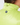 Close-up of a person wearing a bright neon yellow-green puffer jacket, showing the back of the neck, high collar with drawstring, and a circular star logo patch on the upper back.