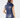 A woman shown from the back wearing a shiny navy sleeveless puffer vest with a high collar, paired with a patterned headband and skirt.