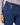 Close-up of a person wearing navy blue tailored pants with a discreet star logo on the fob pocket, paired with a patterned long-sleeve top.