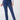 A person wearing a pair of slim-fit navy blue pants, shown from the waist down against a plain light gray studio background. The pants have a small star logo on the fob pocket.