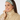 Smiling woman wearing Felicity Snood in Noughty Green lattice print.