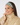 Smiling woman wearing Felicity Snood in Noughty Green lattice print.