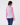 Pink women’s quarter-zip golf pullover with patterned back panel and solid sleeves, shown from the back.