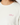 Close-up of a person wearing a white crewneck sweatshirt with a pink embroidered 'GOLF' logo with a star on the chest.
