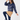 Navy women’s padded golf jacket styled with a caramel winter golf skirt and navy tights.