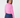A woman wearing a pink ribbed long-sleeve mock neck top and navy blue trousers, photographed from the back.