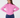 A woman wearing a pink ribbed mock neck long-sleeve top paired with navy blue pants.