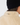 Close-up back view of a person wearing a black ribbed beanie and a cream sherpa fleece jacket with a silver safety-pin style detail on the collar.