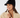 Black women’s ribbed golf beanie with visor, pom-pom and circular star logo, shown on a model.