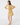 Woman wearing a caramel and parchment color-block ribbed knit top with a caramel golf skort, shown from the front.