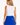 A woman shown from the back wearing a sleeveless athletic attire with a white top section covered in small blue dots and a solid royal blue skirt section with a small white star detail.