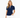 A woman wearing a navy blue short-sleeve golf polo shirt with a white polka dot pattern and white trim along the split neckline and sleeve cuffs, paired with white pants.