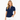 A woman wearing a navy blue short-sleeve golf polo shirt with a white polka dot pattern and white trim along the split neckline and sleeve cuffs, paired with white pants.