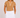 A woman in a tan short-sleeve golf top with white polka dots and white trim, paired with a white mini skirt.