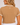 A woman shown from the back wearing a tan short-sleeve crop top with white polka dots, white scalloped trim on the collar and sleeve cuffs, and a small white star detail at the back of the neck.